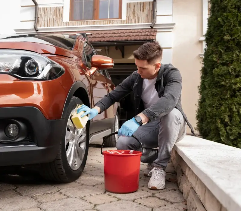 Lavage auto à domicile Sathonay-Camp : professionnel intervenant sur un véhicule
